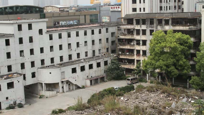 abandoned factory building with ironic quality control reminder painted on the wall