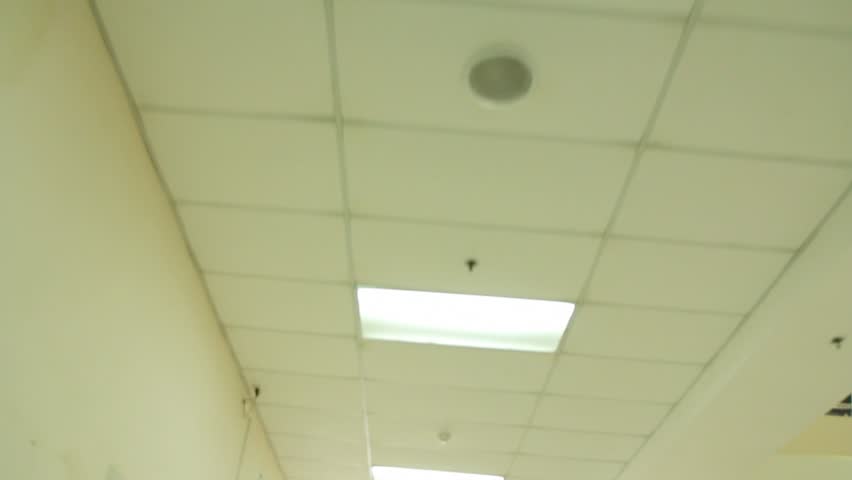 Ceiling along a hospital corridor from patient on gurney's POV