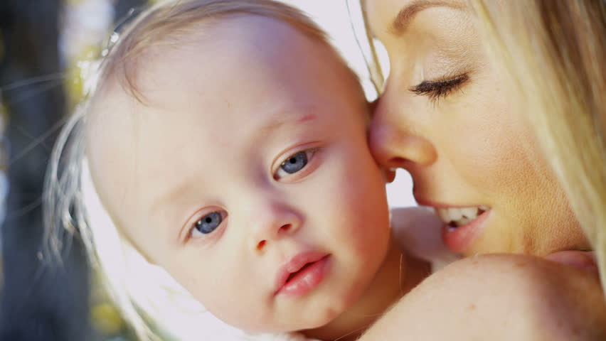 Portrait in close up of beautiful young mother and her baby