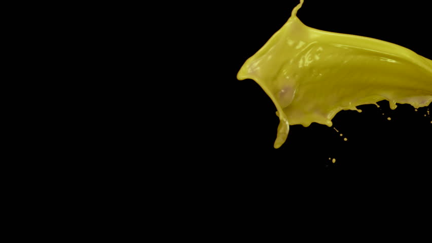 Yellow liquid splash in the air on black background shooting with high speed camera, phantom flex.
