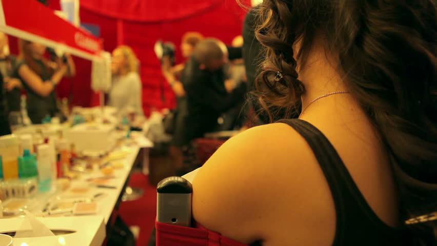 Professional makeup artist putting cosmetics. Fashion Show.