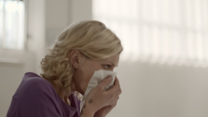 Allergy and health problems for young woman sneezing in office while using laptop computer