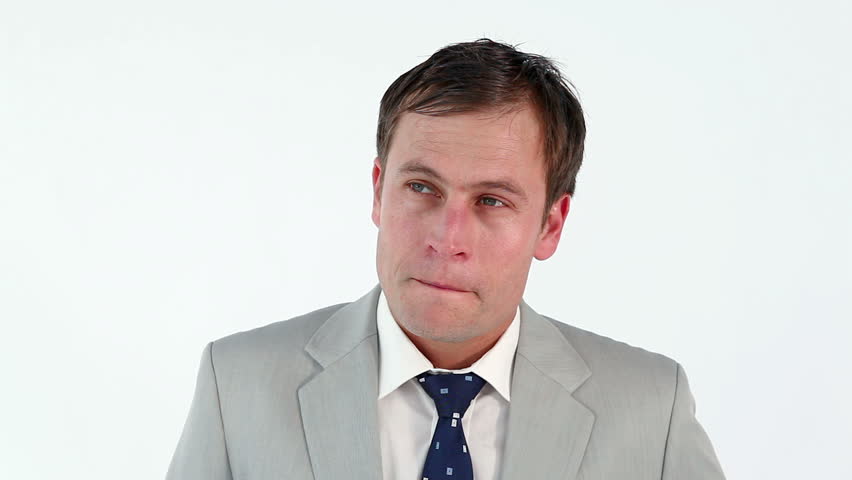 Thoughtful man standing upright against a white background
