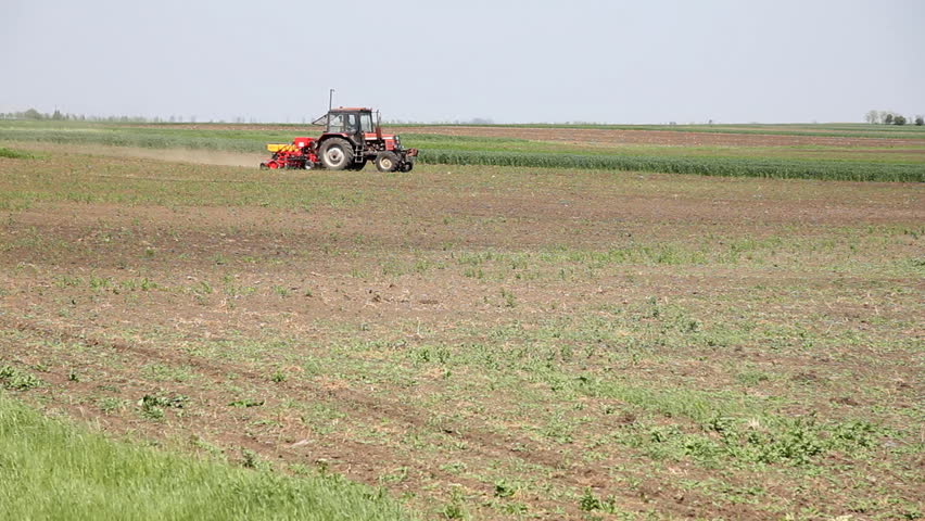Farmer sowing corn and spraying against weeds on a field