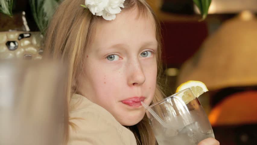 Young girl drinking lemonade