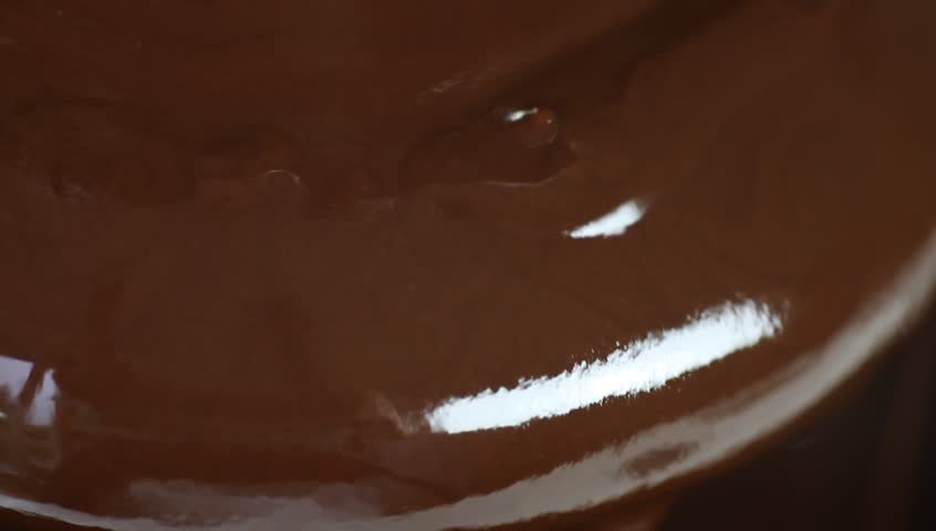 Flowing melted chocolate in chocolate fountain