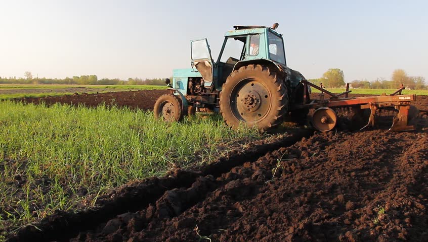 Tractor plowing in the field