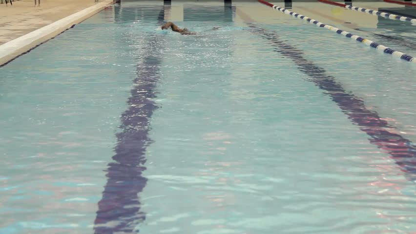 Male swimming in swimming pool in gym