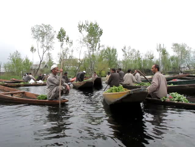 SRINAGAR, INDIA - APRIL 14: Kashmiri men sell their vegetables at a floating market in the early hours before sunrise on April 14, 2012 in Dal Lake, Srinagar, Jammu and Kashmir, India.