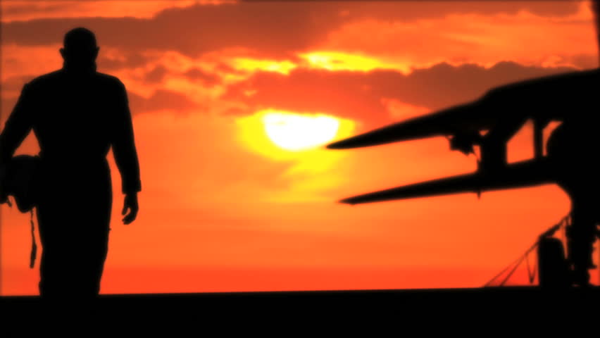 silhouette of pilot and fighter at sunset