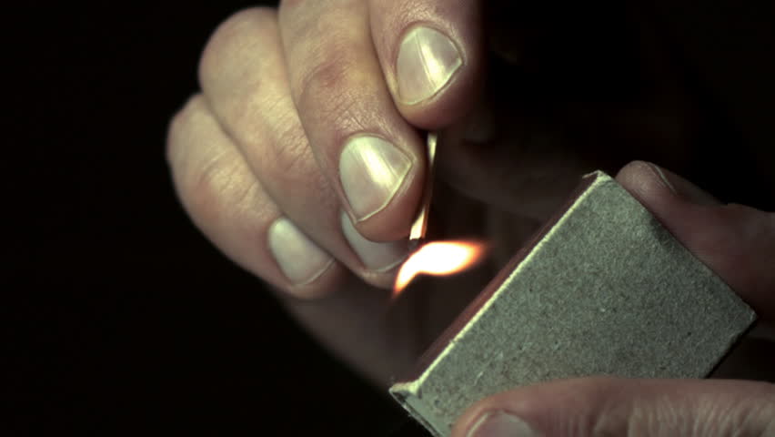 Man lights a match in slow motion 