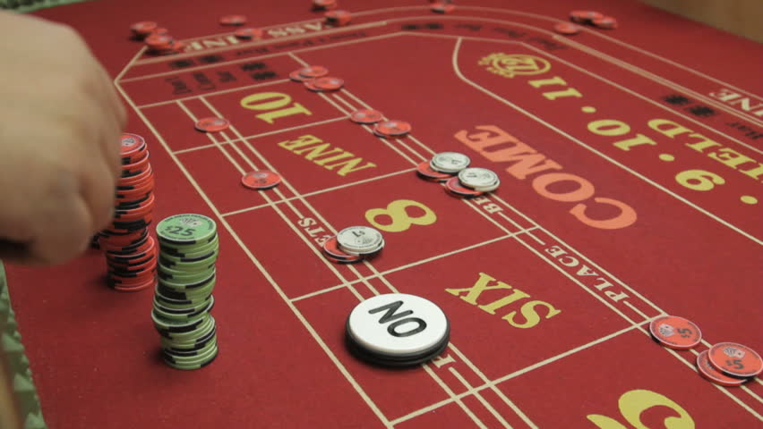 Gambler setting up his bet at the crap table