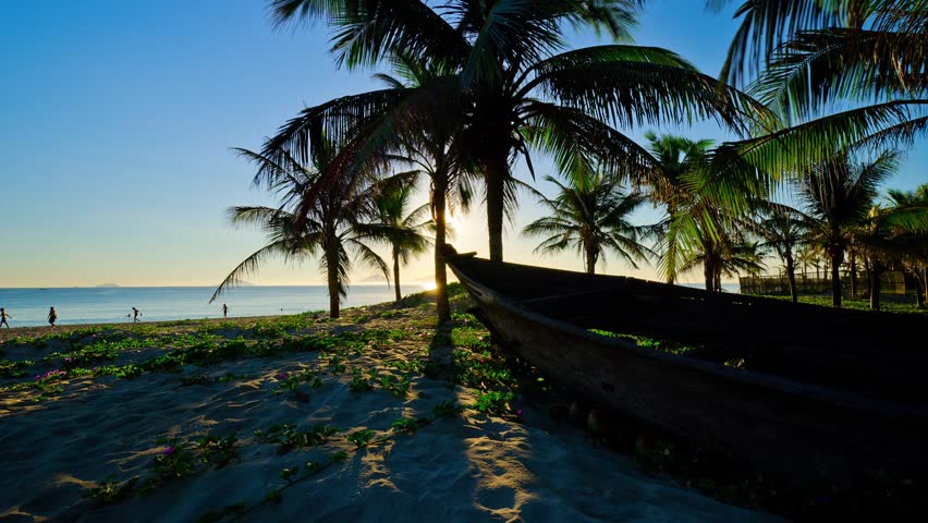Time lapse of rowing boat on beach at sunrise Cau Dai Beach, Hoi An, Vietnam 