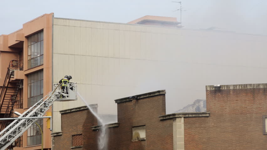 firemen hose down fire in barcelona