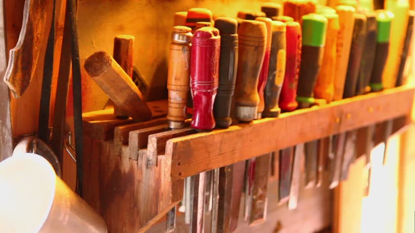 Lot of tools on shelve in workshop with mountains outside window