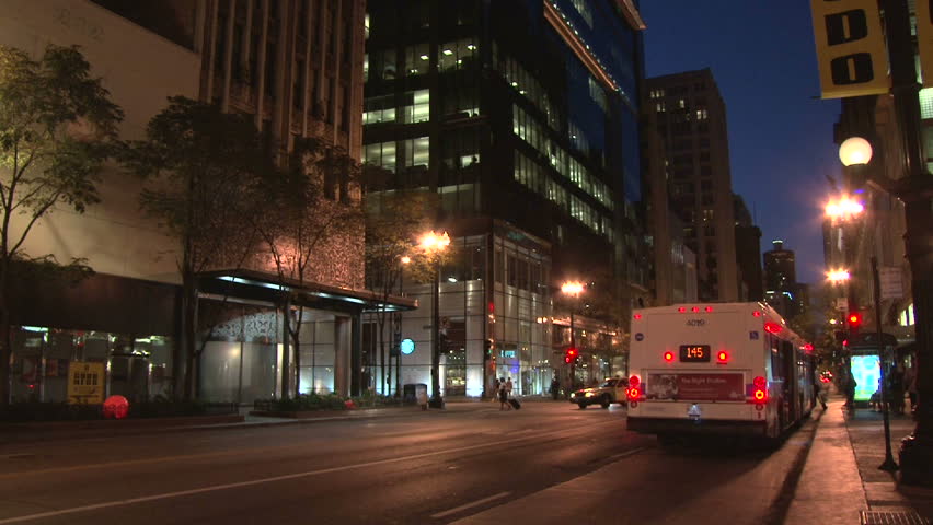 CHICAGO CIRCA - APRIL 2011: Downtown area with bus driving down and away through the city with sound.
