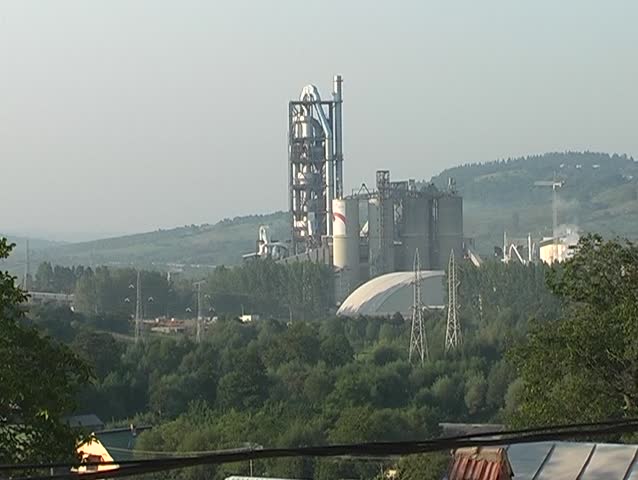 Big cement factory engulfed in smoke and dust