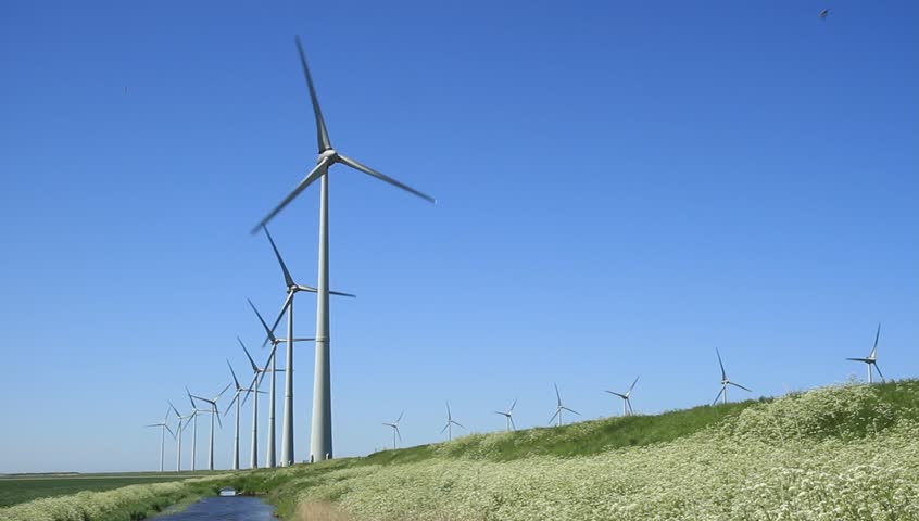 Modern wind turbines generating clean energy in the green countryside.