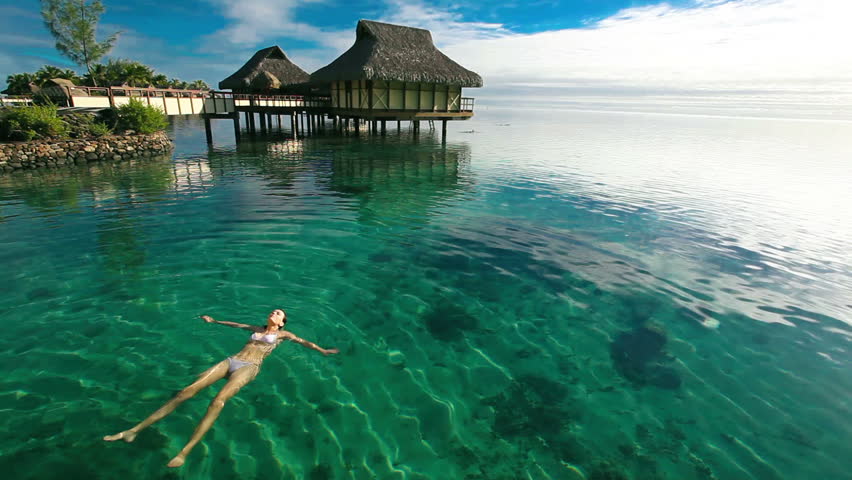 woman swimming in tropical coral lagoon