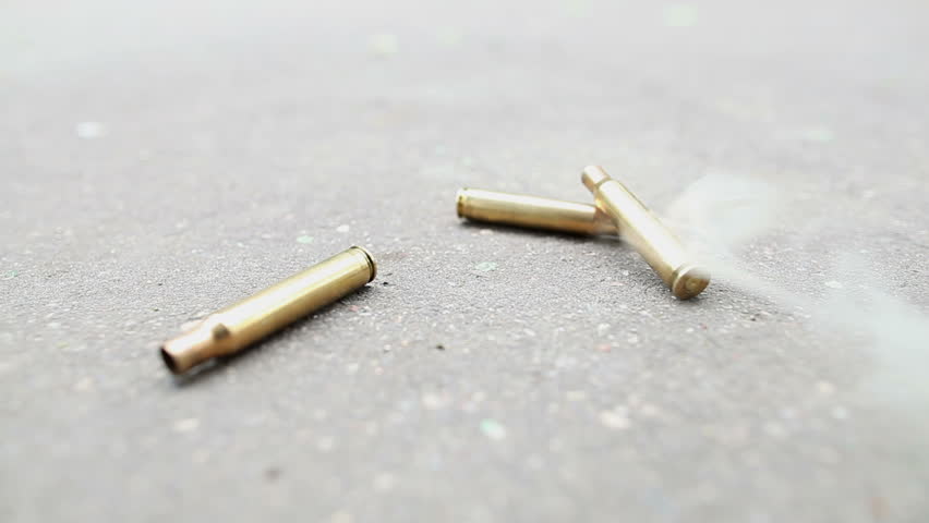 spent ammunition cartridges falling from a rifle