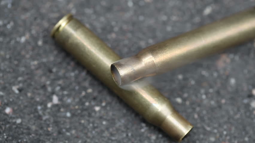 spent ammunition cartridges falling from a rifle