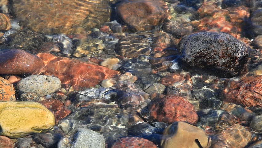 Close up of waves crashing on stony Beach Shore on the german Baltic Sea