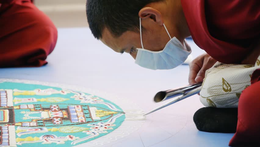 NOVOSIBIRSK - CIRCA APRIL 2012: Tibetan monks making sand mandala circa April 2012 in Novosibirsk, Russia.