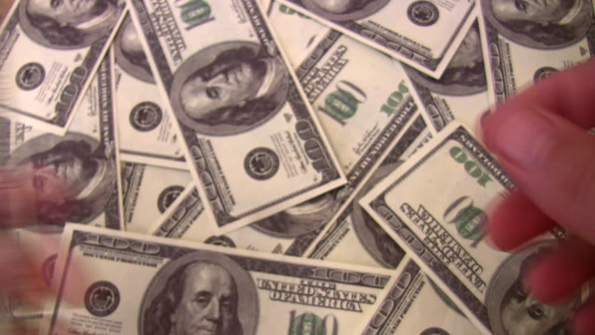 count dollars in hands on dollar background 