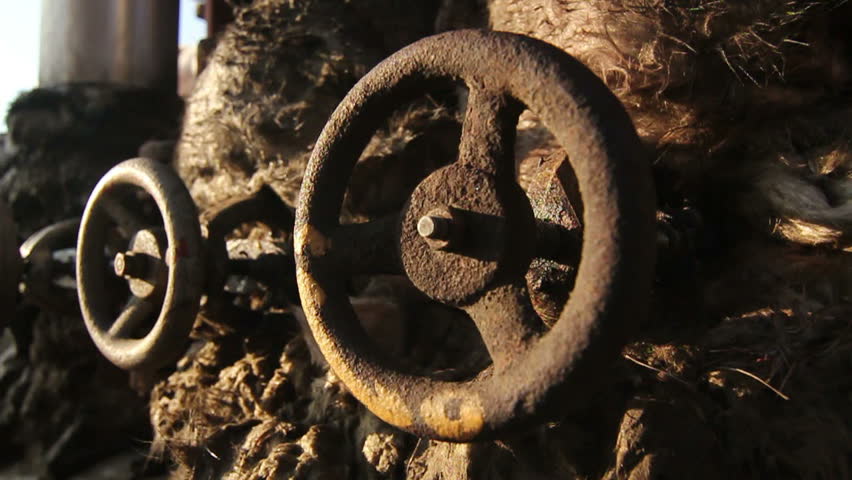 Several rusty valves on the pipes