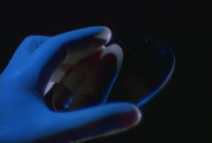 Gloved hand holding silicon wafer
