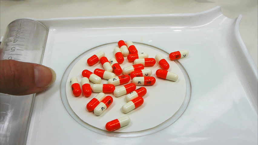 a pharmacist counting pills