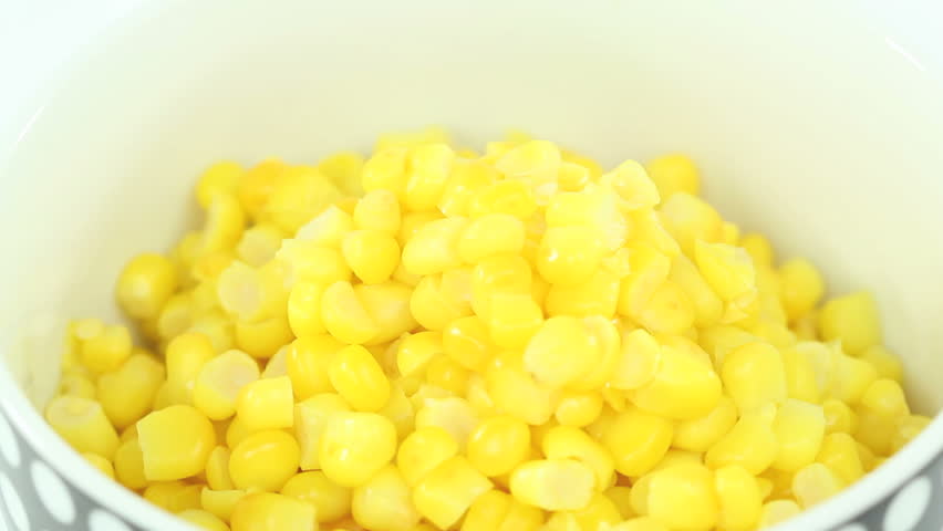 Bowl of healthy boiled fresh corn slowly rotating in a seamless video loop