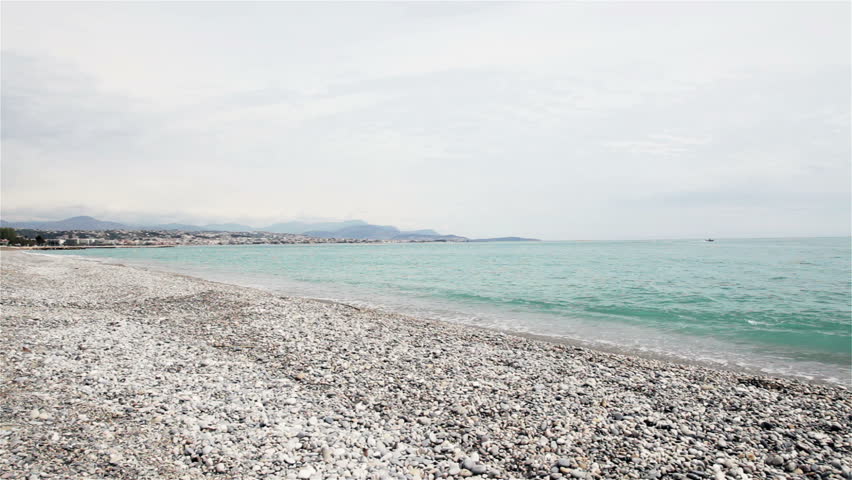 Stony coastline on French Riviera with Nice in background