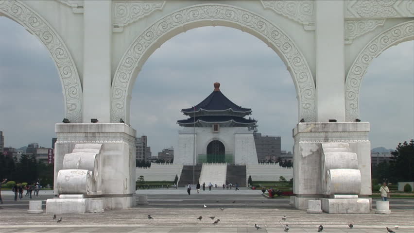 View of Chiang Kai-Shek Memorial Hall from far away through archway in Taipei Taiwan
