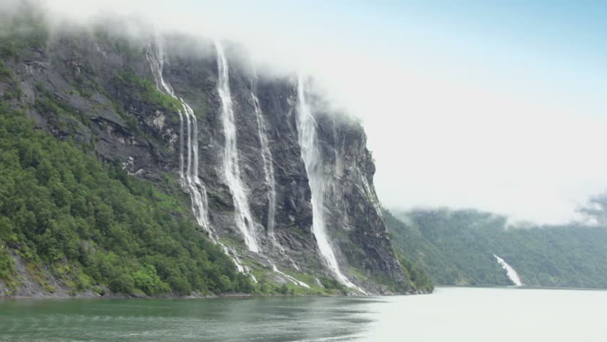 Seven Sisters waterfall on rocky mountain at shore of fjord in Norway
