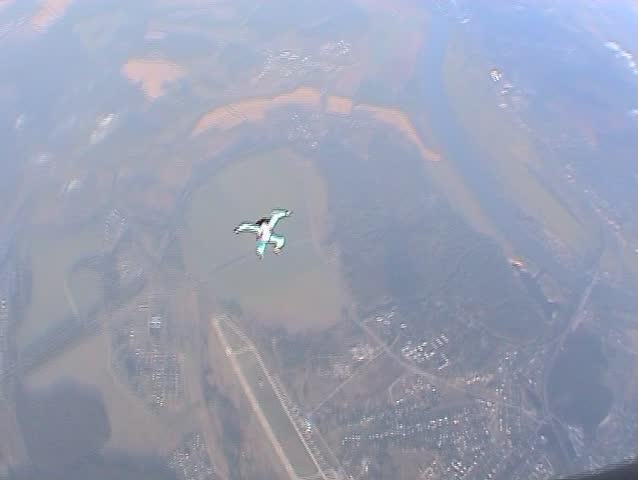Skydiving above clouds - one minute of free fall in sitting position