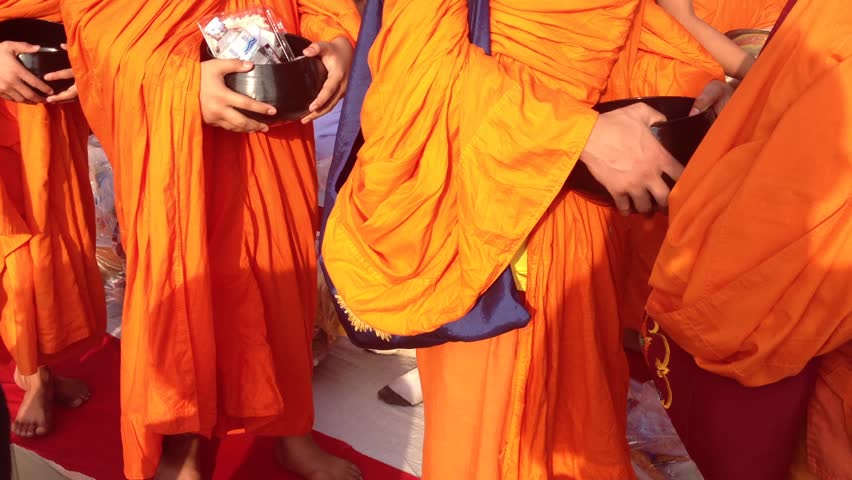 BANGKOK - MARCH 17: Monks are participating in a Mass Alms Giving of 12,600 monks for the Makha Bucha celebrations on March 18, 2012 in Bangkok, Thailand.