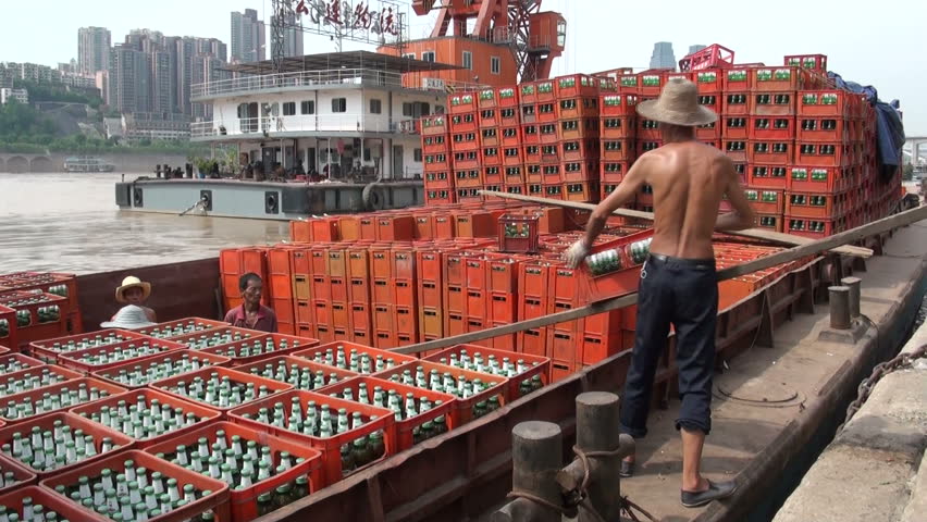 CHONGQING - AUGUST 17 2010: Workers are loading a ship with crates of beer in Chongqing, China