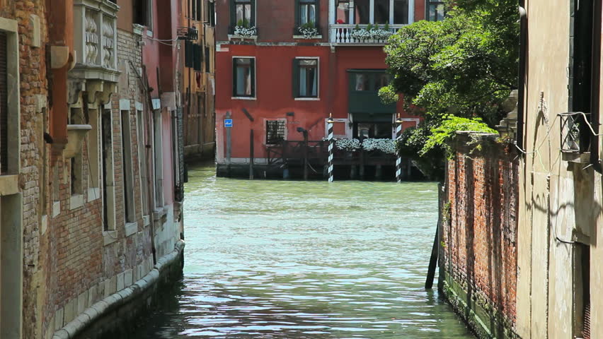 VENICE - JUNE 26: Two white taxi canal boats passing each other in a wide canal on June 26, 2012 in Venice, Italy.