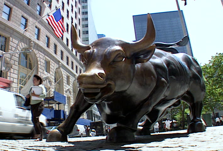 NEW YORK - Circa 2002: Charging Bull bronze statue in front of the New York Stock Exchange building in 2002.