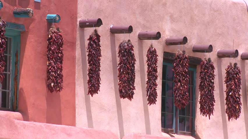 Chili peppers hanging from an adobe building