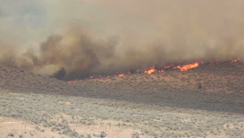 FOUNTAIN GREEN, SANPETE, UTAH 25 JUN 2012: Fire out of control on mountain. Forest wildfire intense flames and smoke. Dangerous and destructive blaze destroyed dozens of home and caused death. 