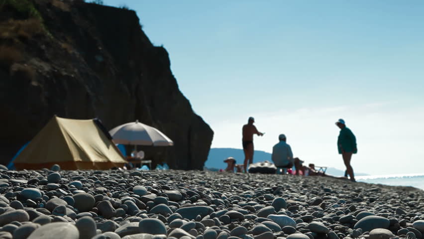 The family camped by the sea, focus on foreground