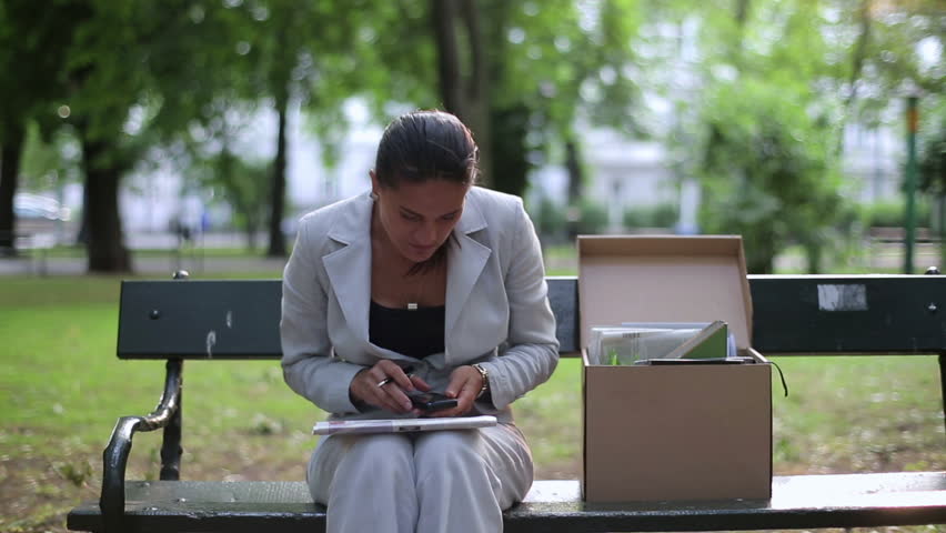 Just fired, unemployed businesswoman looking for job in newspaper