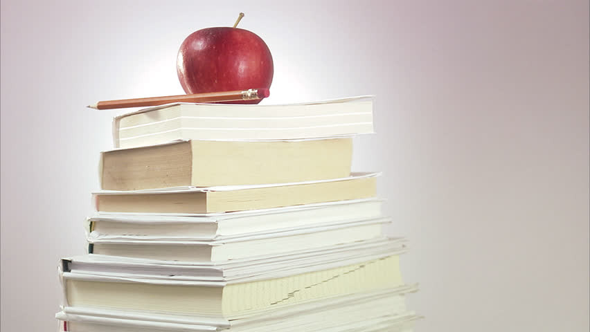 An apple on a pile of books.