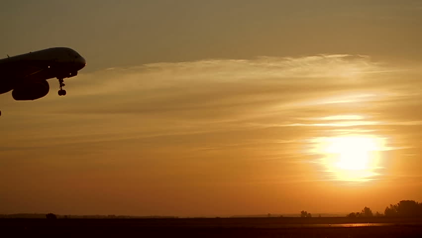 Plane takes off at sunrise background