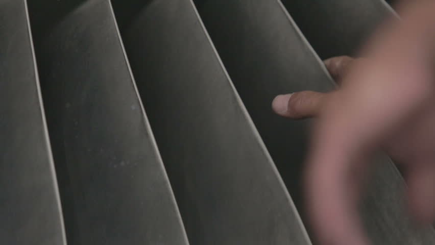 Man checks propeller blades of the turbine engine aircraft