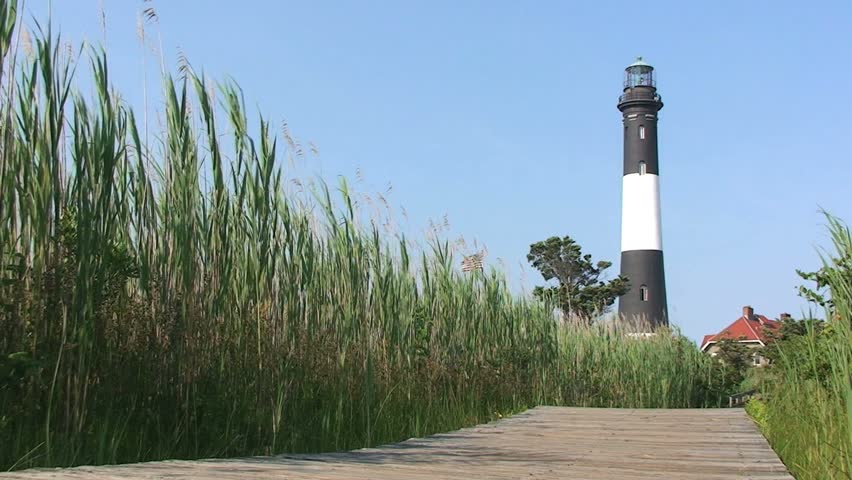 Light House with Boardwalk and Green Grasses