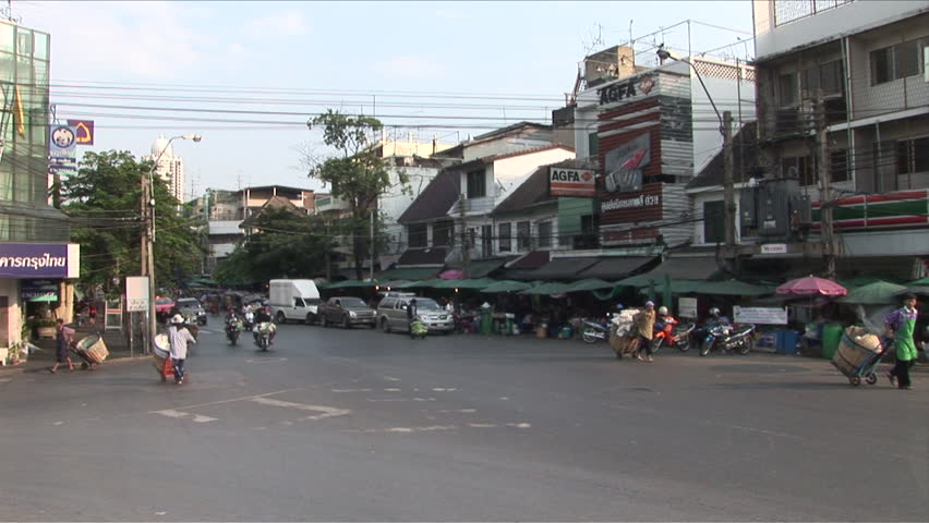 Bangkok, Thailand - CIRCA December, 2006: A busy intersection with cars and scooters and buses going in every direction during the day