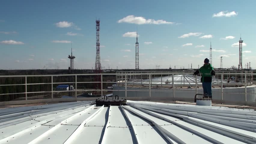 Worker on a top of a huge oil tanker